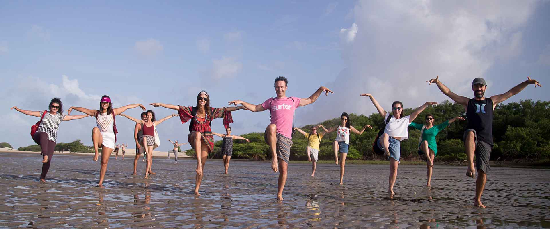 A group of people posing in a yoga position