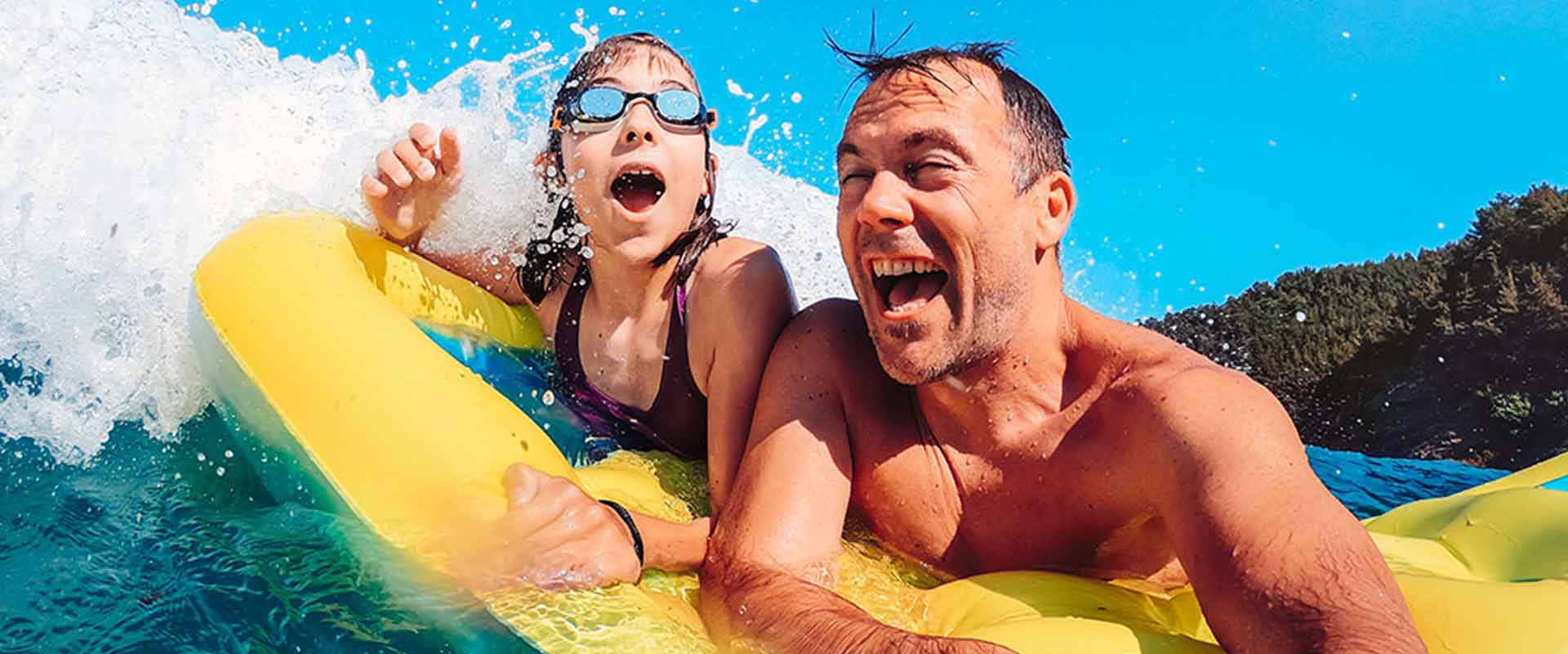 Father and kid enjoying water sports