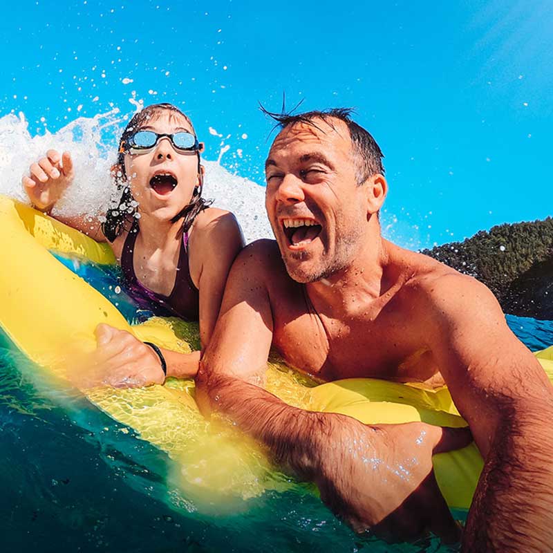Father and kid enjoying water sports