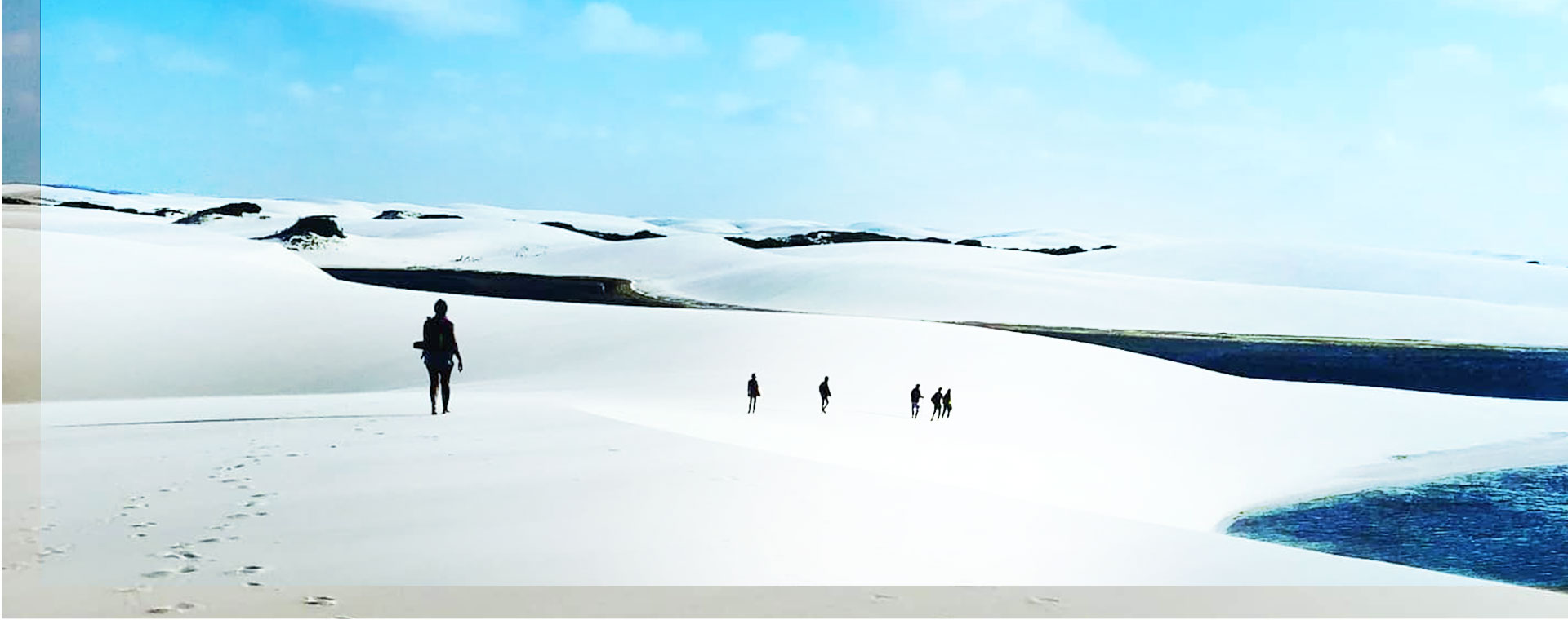 People travelling through the sand dunes in Atins