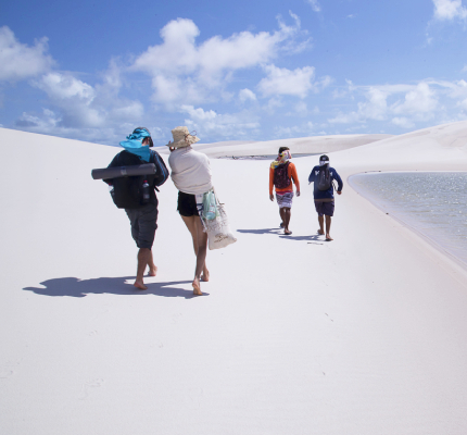 group of people walking along the dunes in Atins