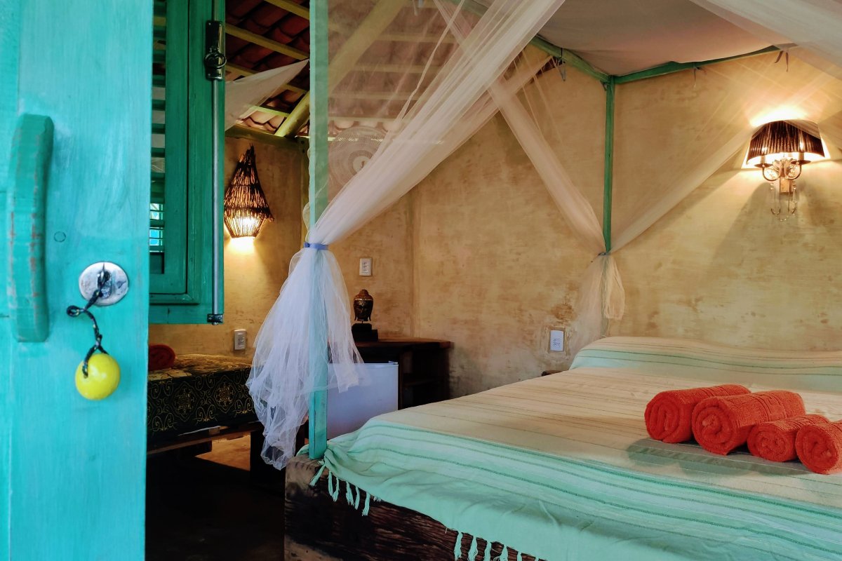 View of the bedroom of the Standard Chalet Triple at Convento Arcadia, Atins