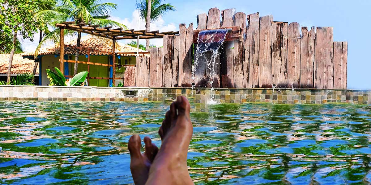 A person enjoying the view of the pool in Convento Arcadia, Atins
