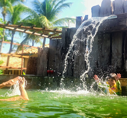 People enjoying the pool at Convento Arcadia, Atins
