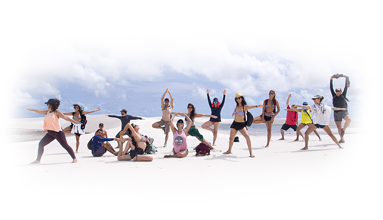 Group of people doing yoga on the beach