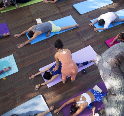 Group of people engaging in a yoga pose at Convento Arcadia, Atins