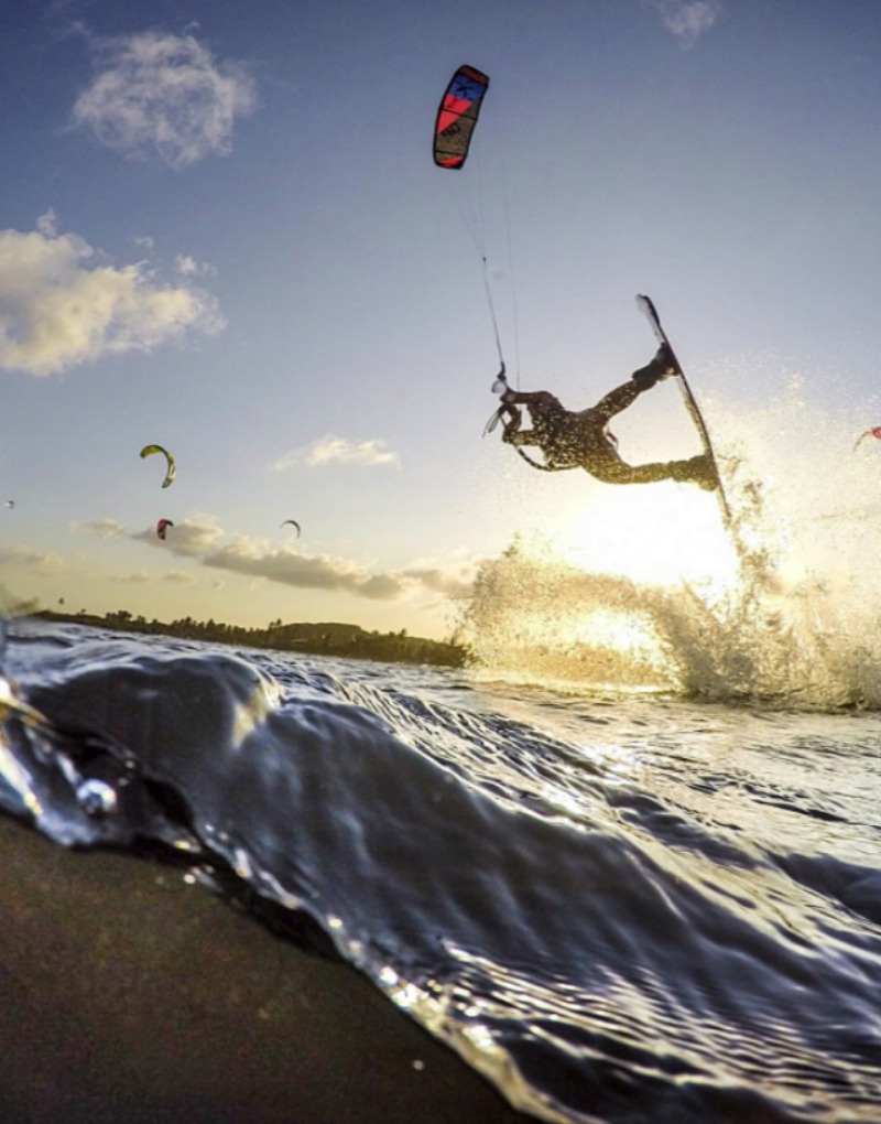 a man doing kite surfing tricks