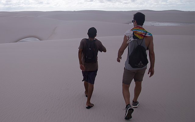 A guide taking a guest on a tour of the sand dunes