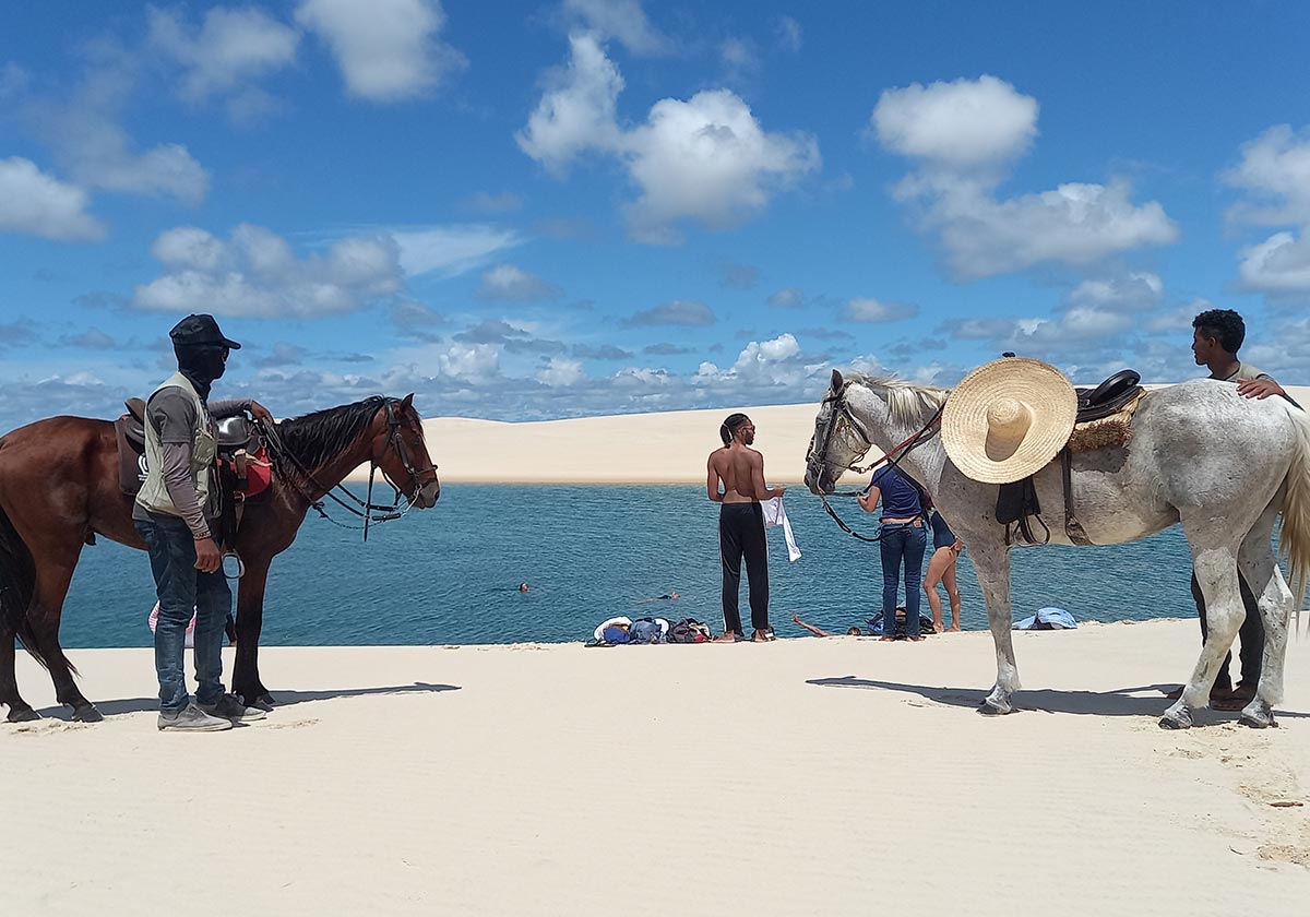 A group of people taking a break from horseback riding