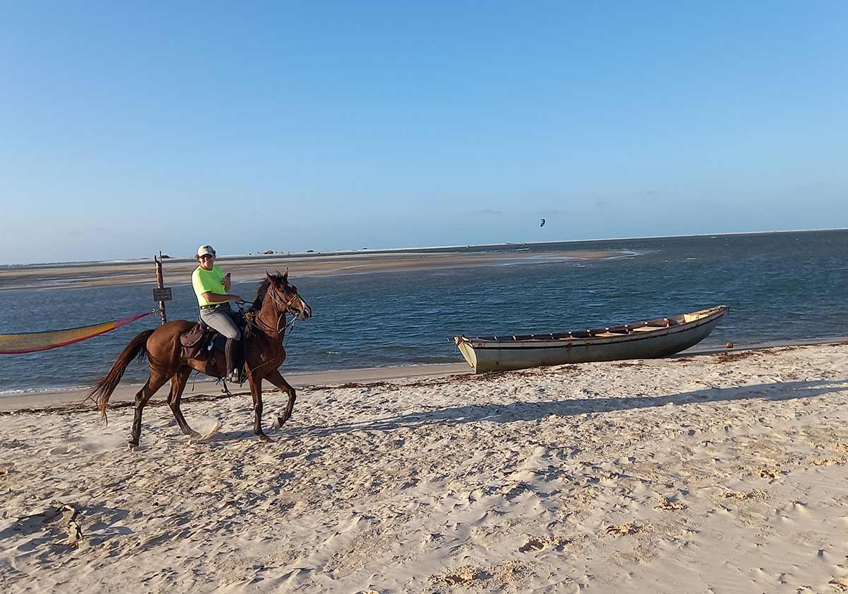 A person horseback riding across a lagoon