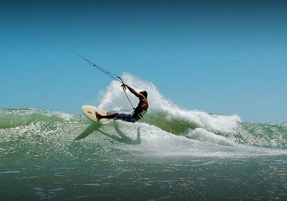 man kite surfing with good waves