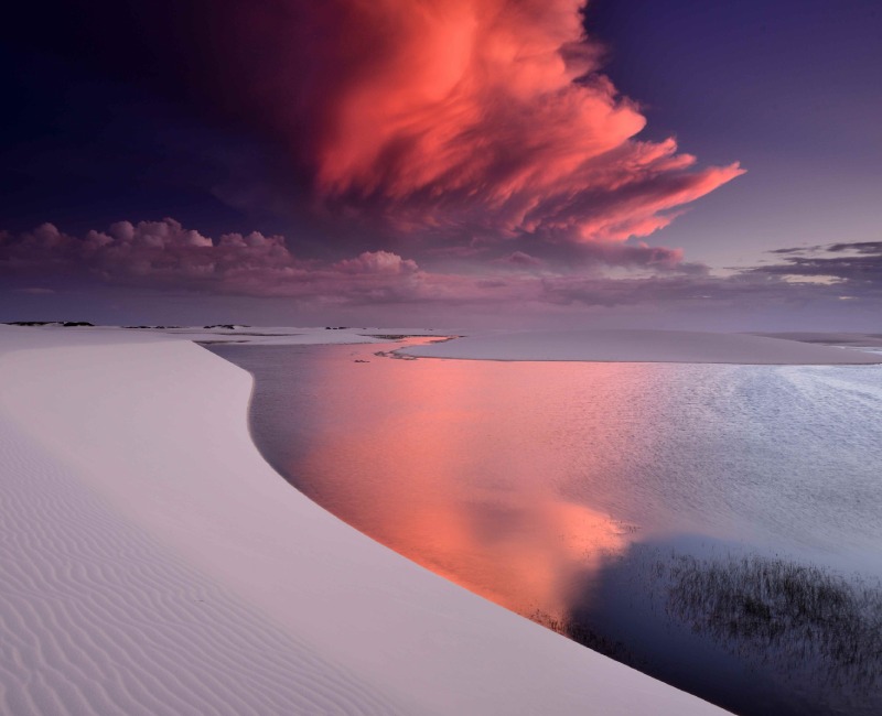 blue waters with red hue clouds