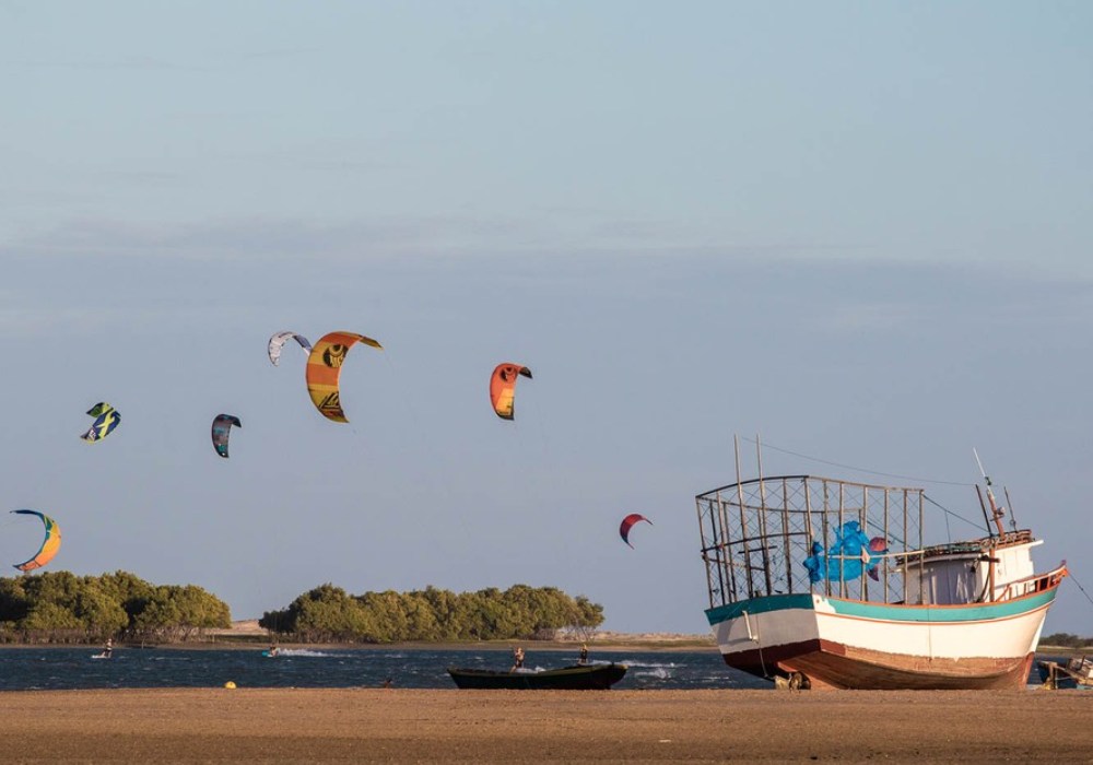 boats at the beach and kitesurfing