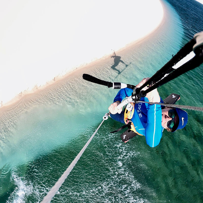 person taking pictures while kite surfing
