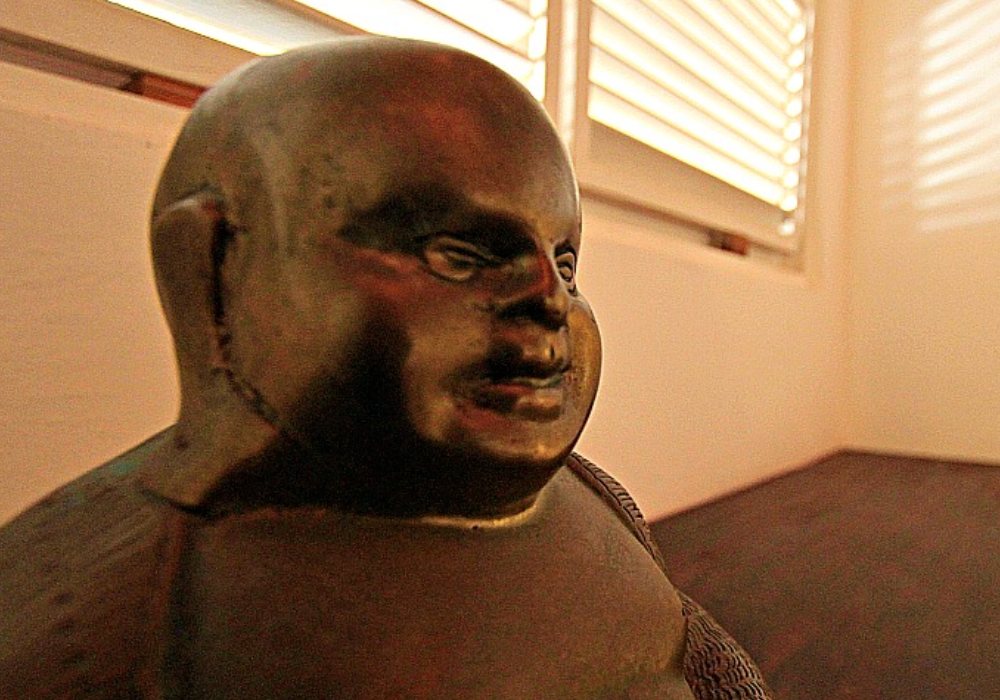 wooden coloured statue of bald man